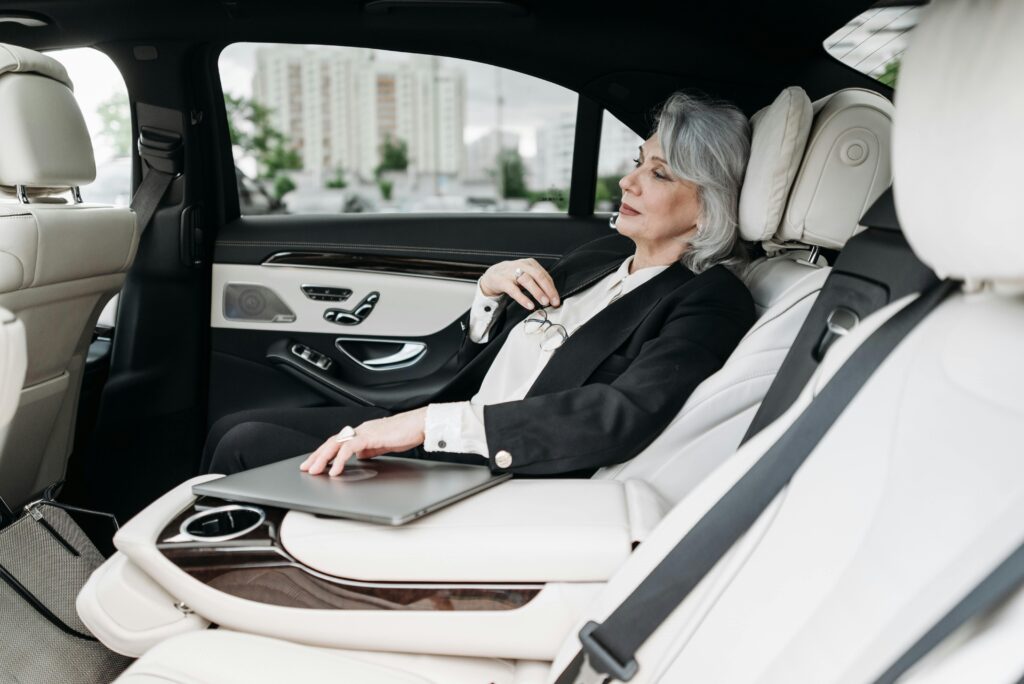 Woman in Black Suit Sitting on Car Seat